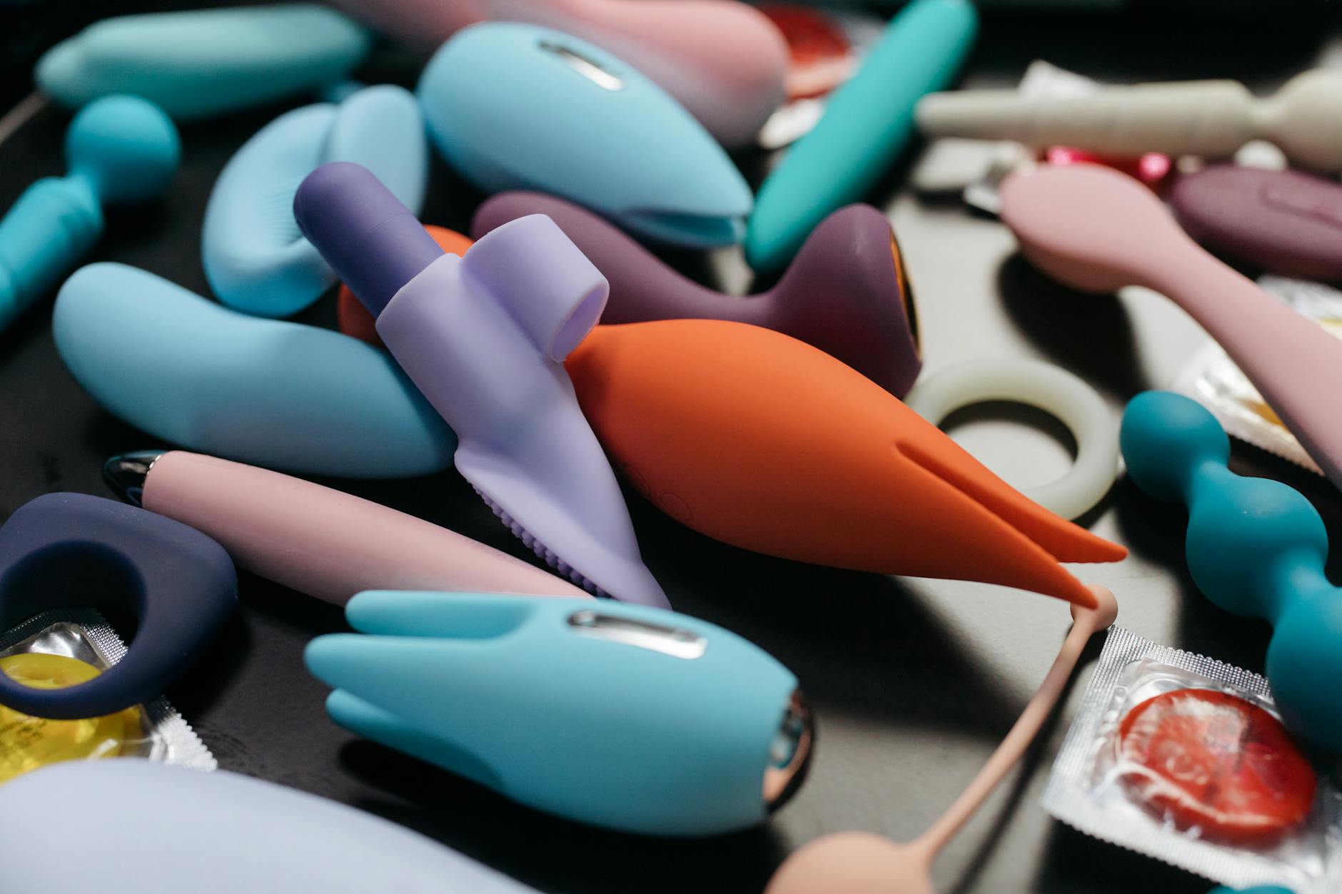 Close-up of hands holding a sleek vibrator, representing intimate connection and shared pleasure.