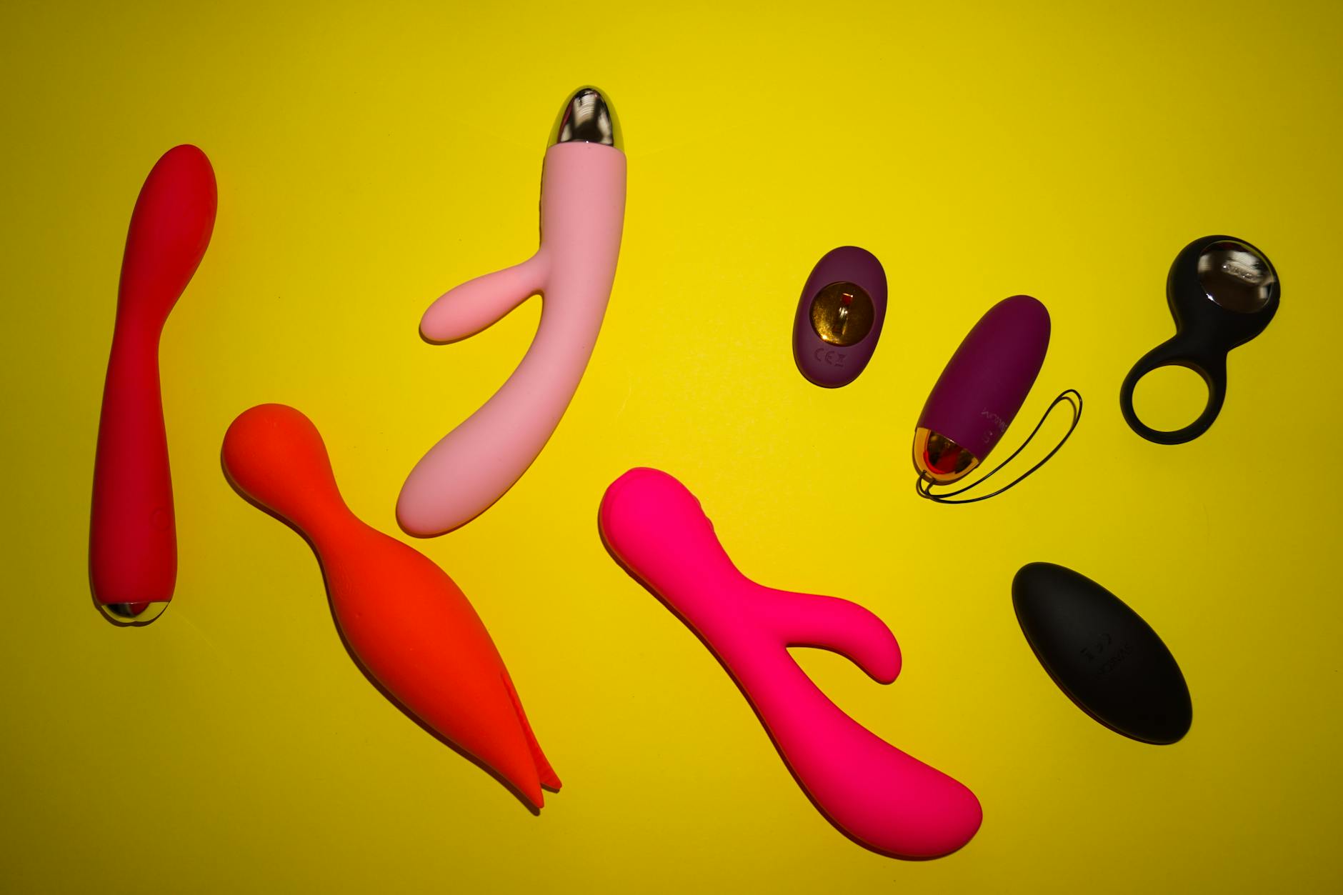Sleek vibrator on white silk fabric, representing modern pleasure tools