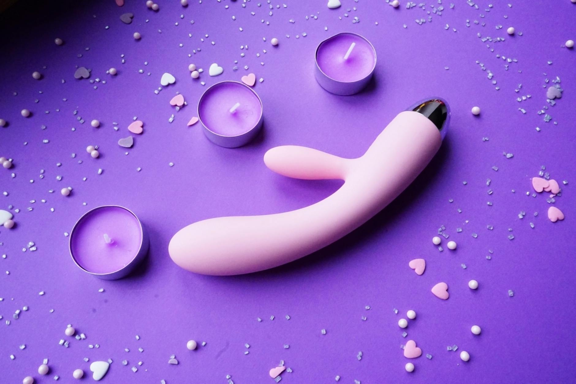 Colorful lemon adult toys and vibrators arranged on a bright yellow surface