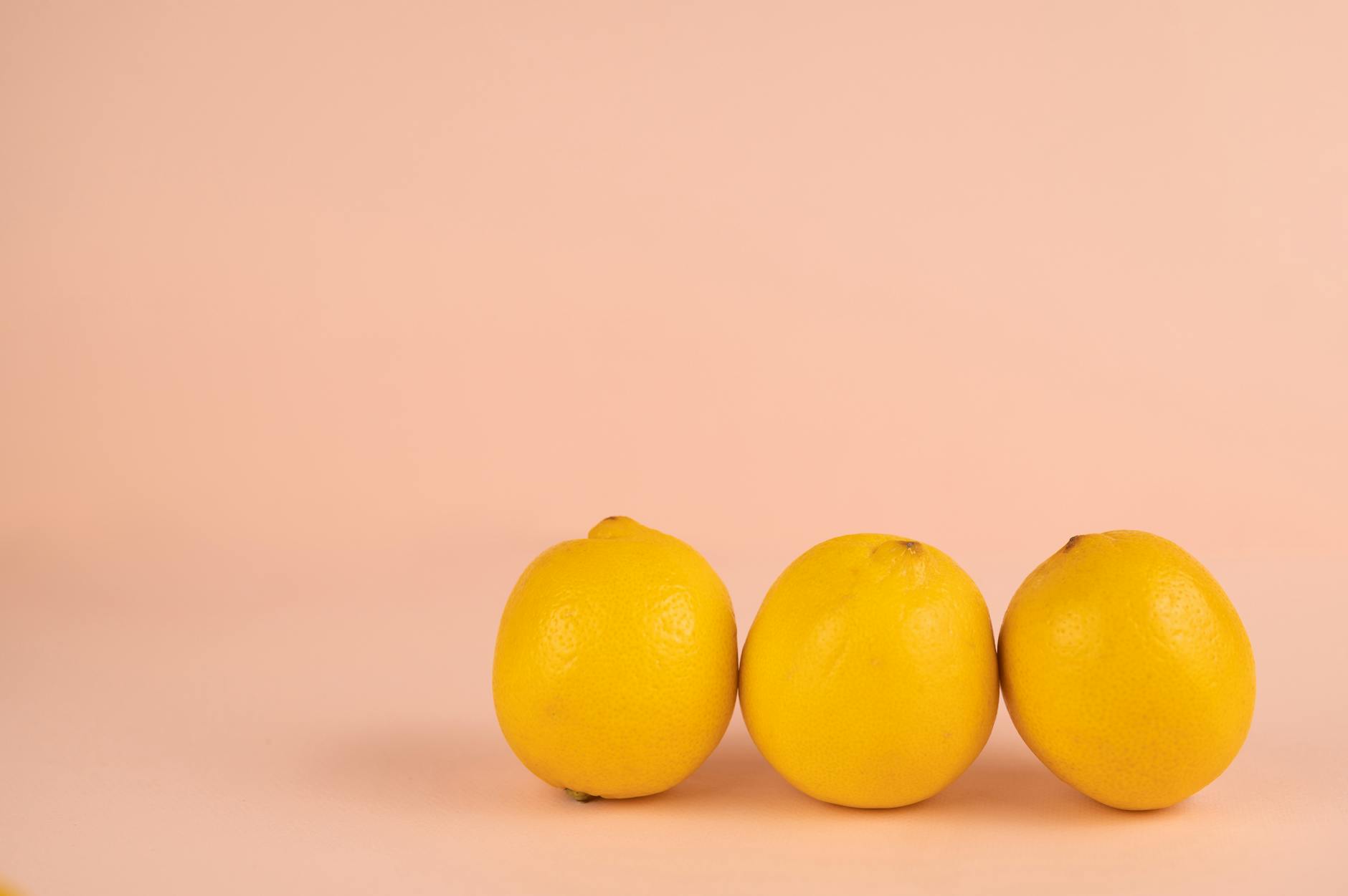 Bright ripe lemons arranged on a pastel background, symbolizing fresh approaches to intimacy